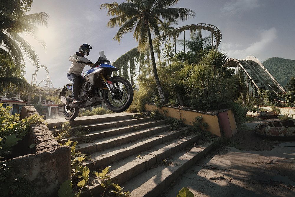 An AI-generated image of an F 450 GS rider jumping a set of stairs in an abandoned amusement park.