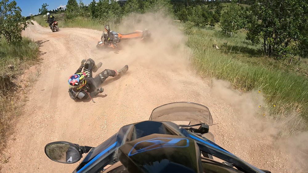 rider's view of Spurgeon crashing in the dirt ahead of him with Stevan riding off in the distance