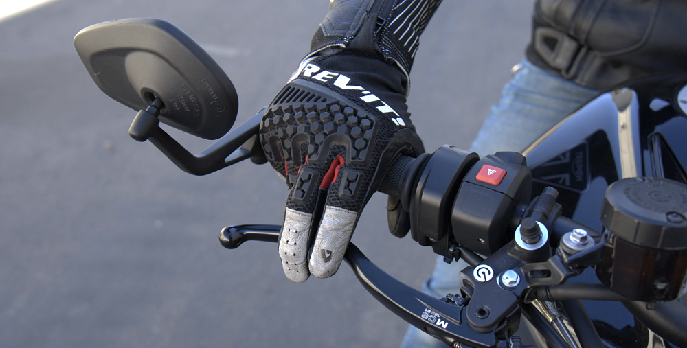 close view of rider's hand on the throttle with two fingers on the front brake lever