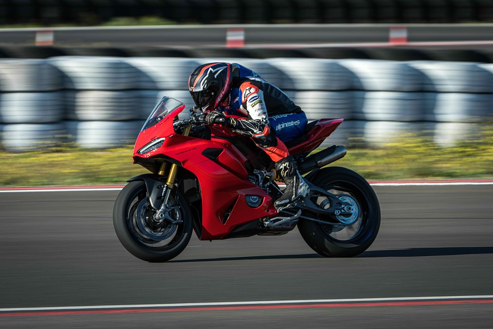 Zack riding a red Ducati Panigale V2 on the track