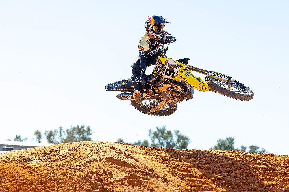 Roczen on his yellow Suzuki doing a 'Bubba scrub' over a jump