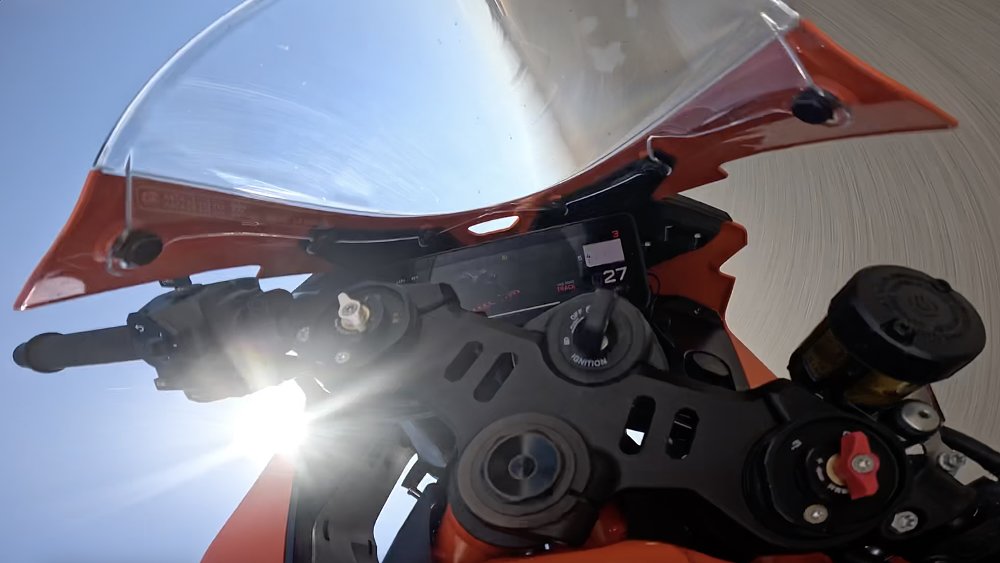 On-board camera image from a KTM 990 RC R during a highside crash, upside down and showing mostly sky.