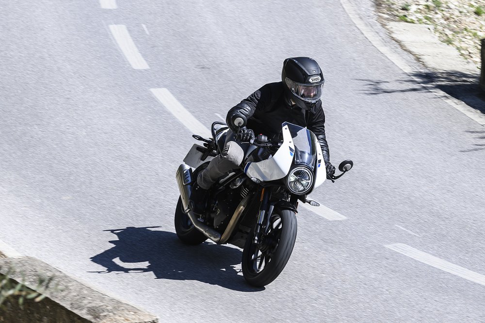riding the white Thruxton on a mountain road in Spain