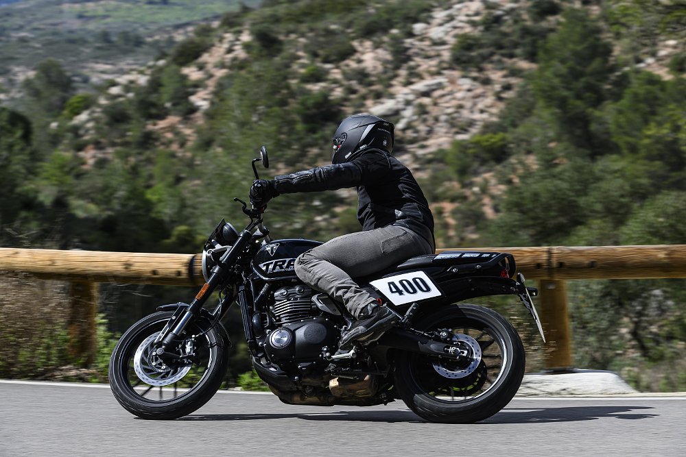 riding the black Tracker 400 on a mountain road in Spain