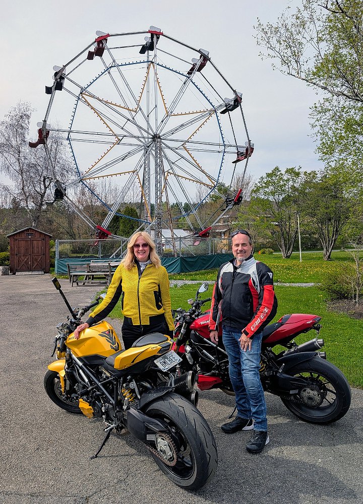 the author and her husband with their Streetfighters parked with a Ferris Wheel in the background
