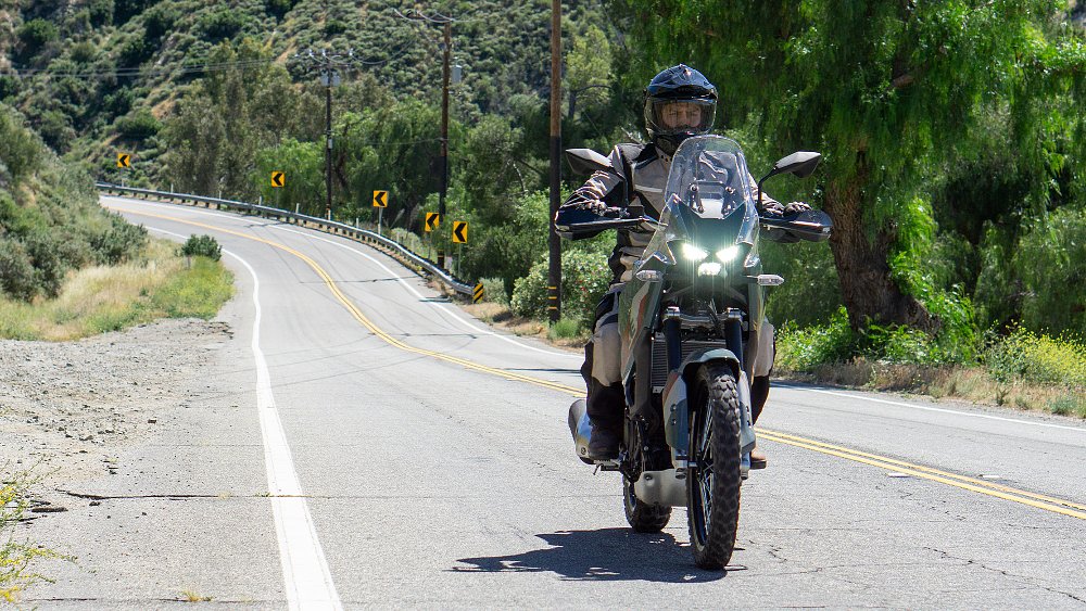 Dustin rides the KLE500 SE along a canyon road.