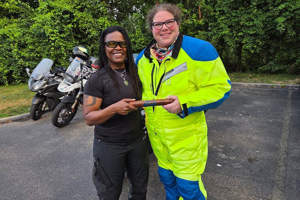Two WR3 Ride participants pose with the WRWR 2019 baton.