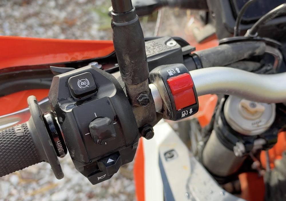 2027 KTM 690 Rally left switchgear detail, including rocker switch for toggling between fuel tanks.