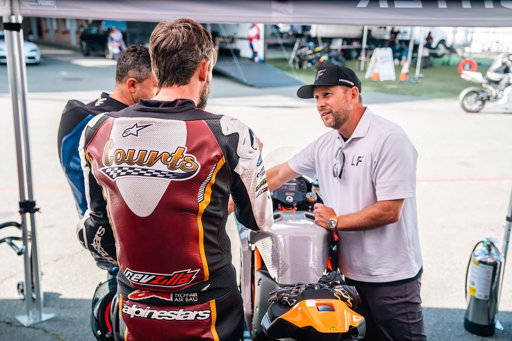 Lightfighter CEO Brian Wismann briefs two riders before a session at Sonoma Raceway.