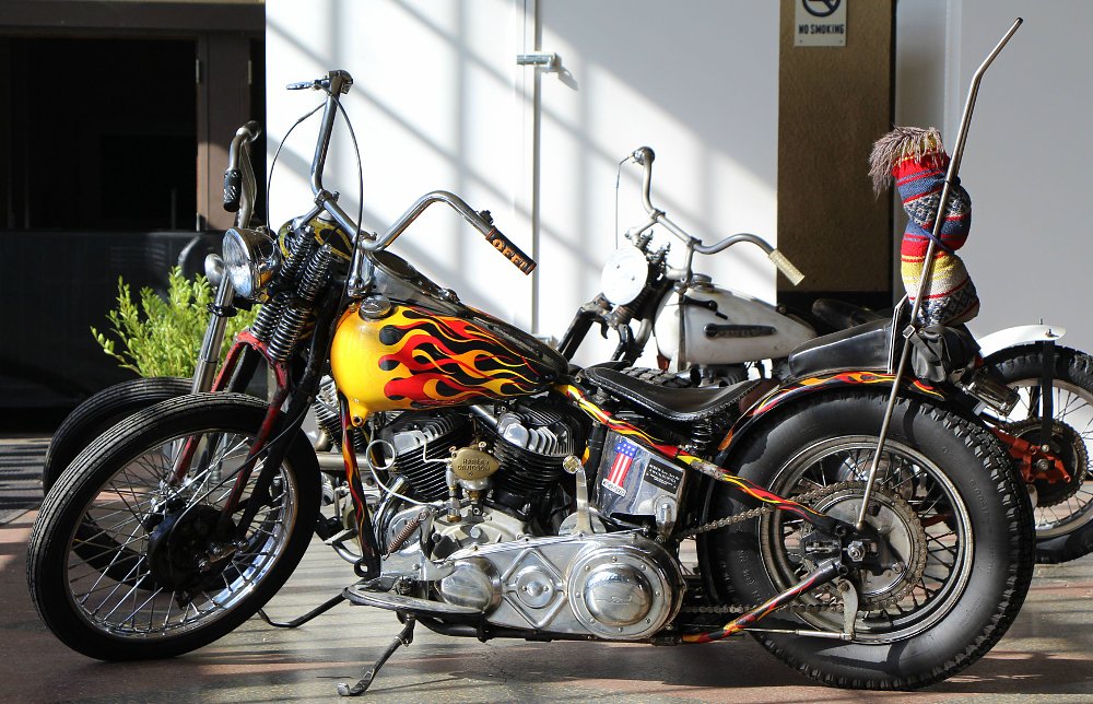 A custom motorcycle with a sissy bar