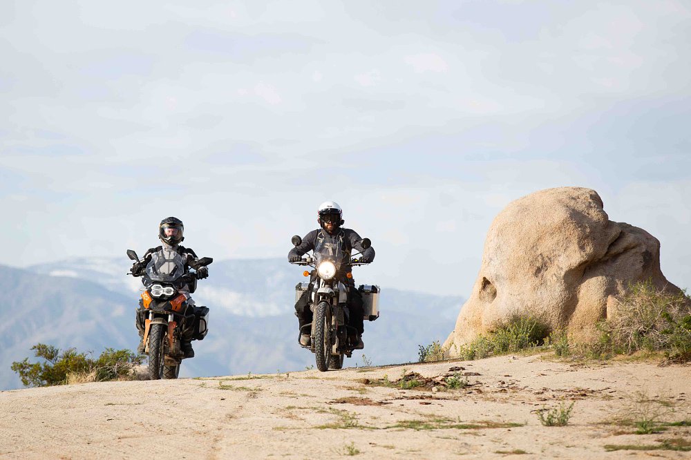 two adventure bikes riding in the desert