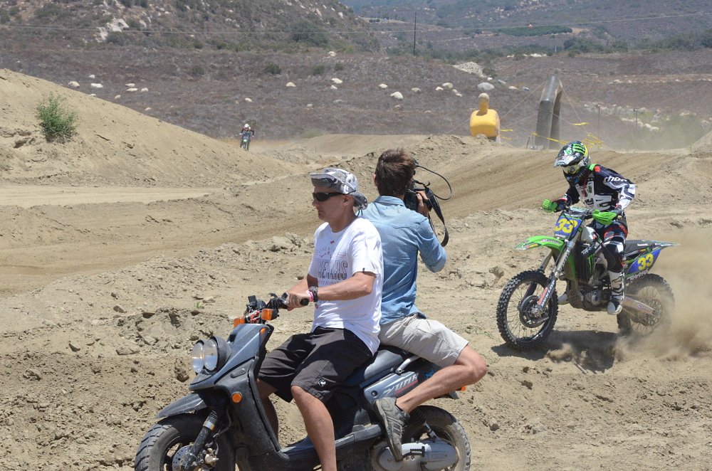 Spenser hanging off the back of his Zuma 2-stroke to capture those perfect shots