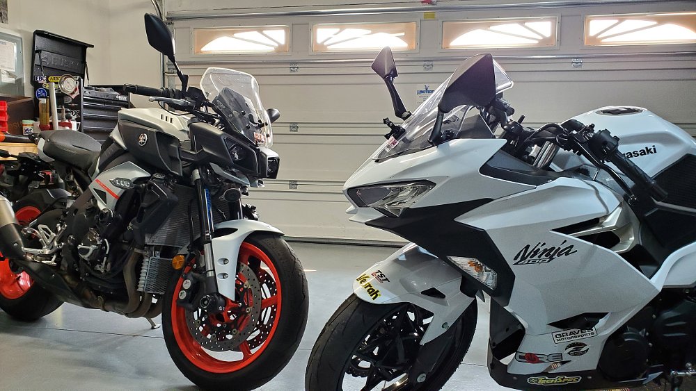 Kawasaki Ninja 400 and a Yamaha MT-10 in the garage