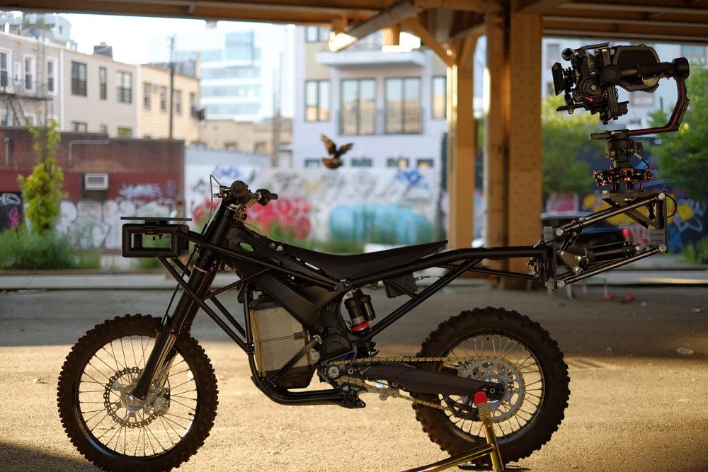 Agile camera bike left with dirt wheels