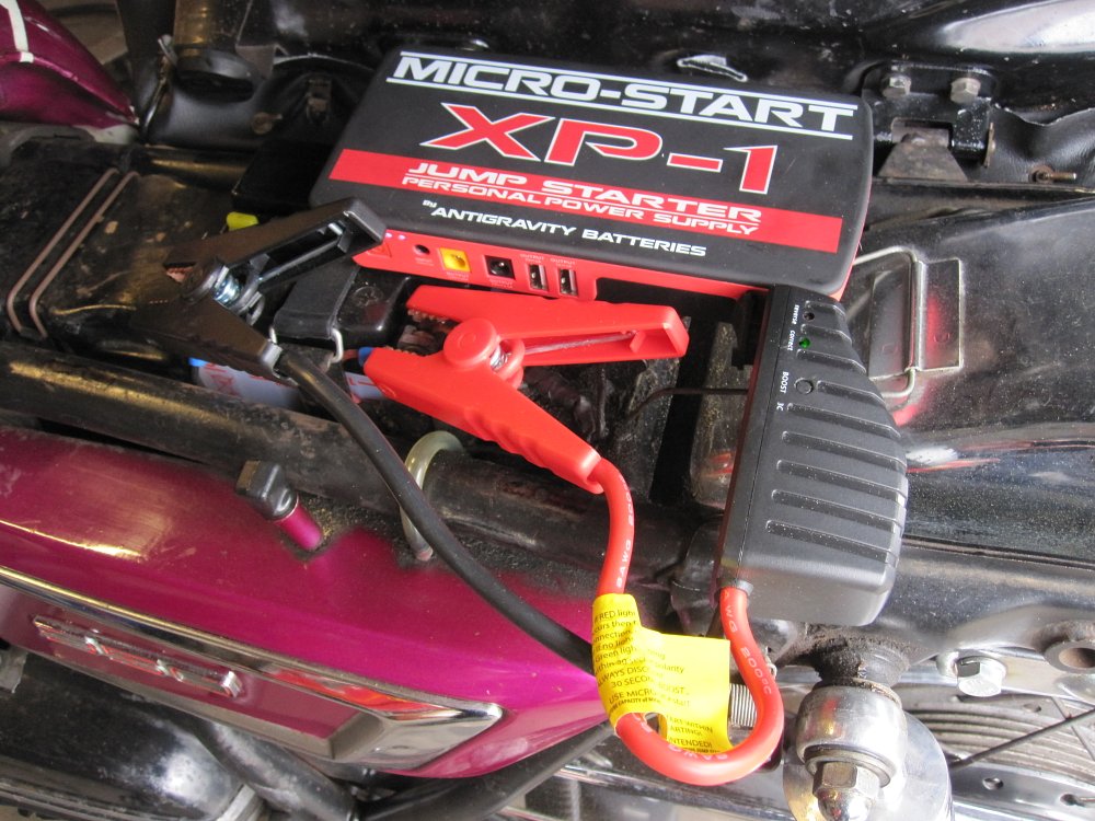 Using a jump pack or personal power supply to jump start a motorcycle battery.