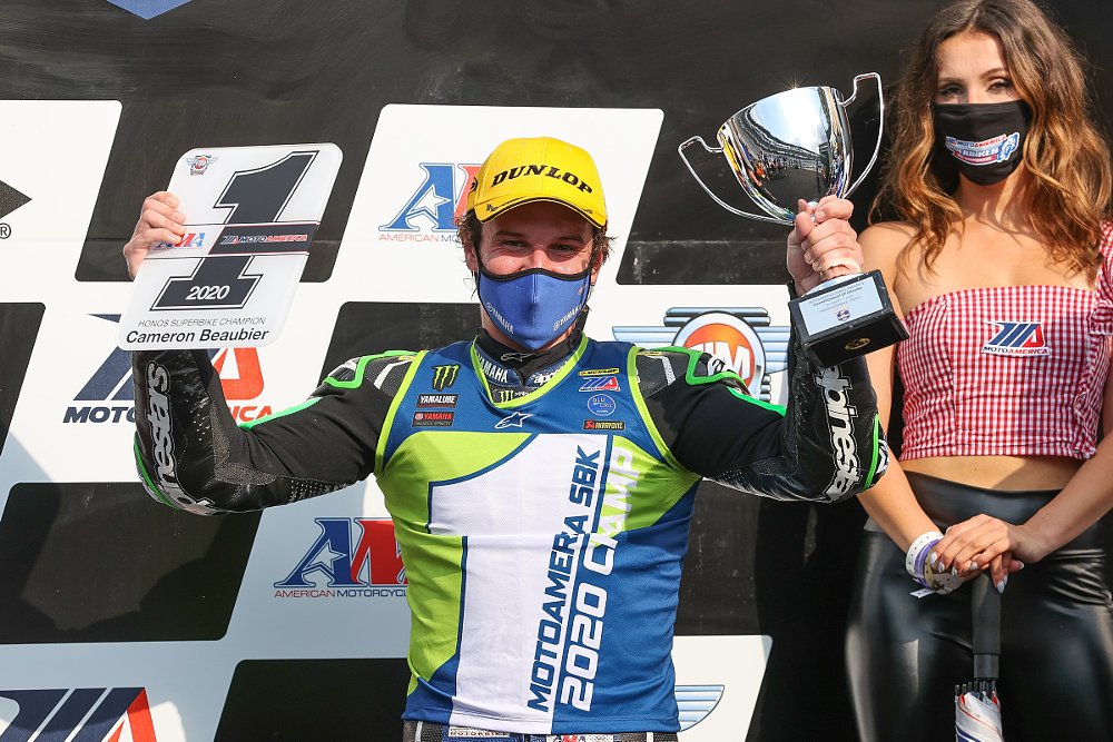 Cameron Beaubier holds up his fifth number one plate