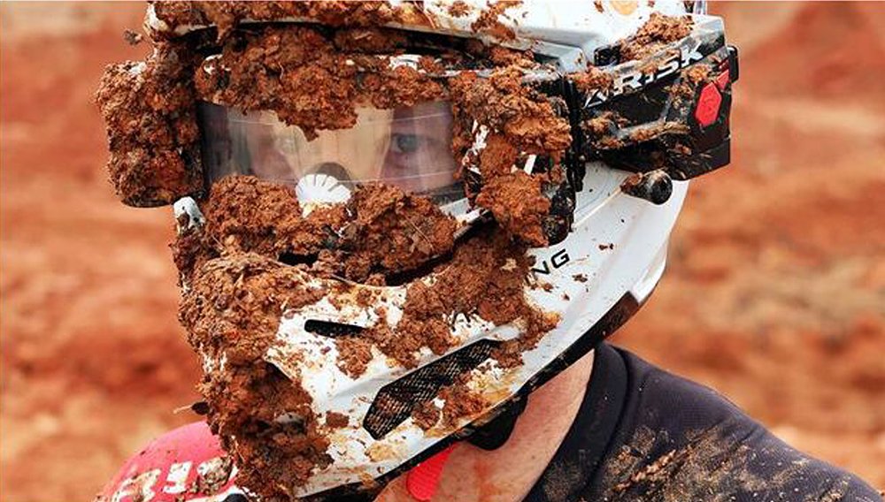 Muddy helmet with clear vision utilizing the Risk Racing roll-off system.