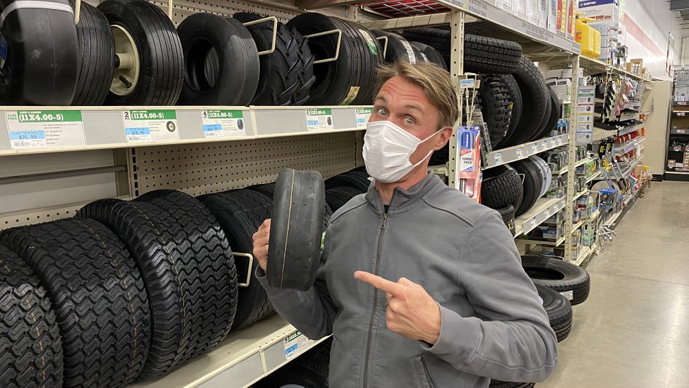 Ari with a tiny slick lawn mower tire in Tractor Supply