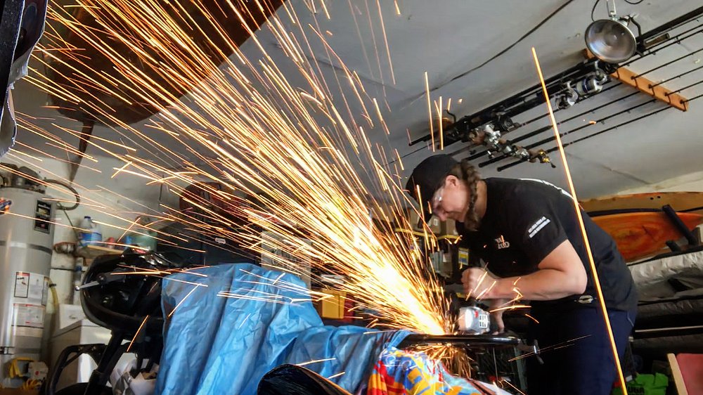 Alyssa takes a grinder to the metal frame of her motorcycle resulting in a shower of sparks.