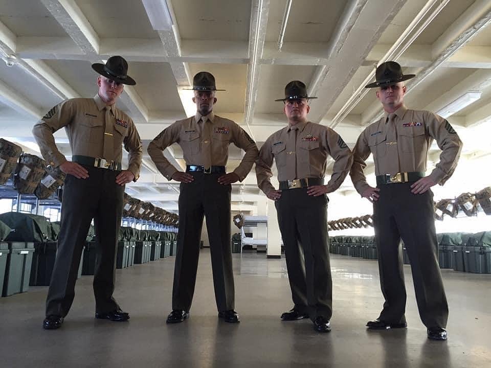4 marine drill sergeants posing in the barracks