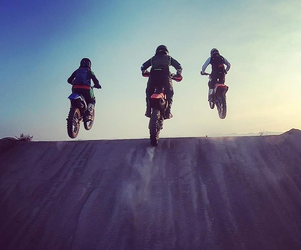 racers off-road taking a jump