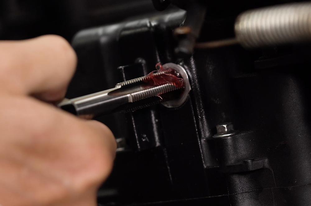 Grease on a tap will help capture metal shavings.
