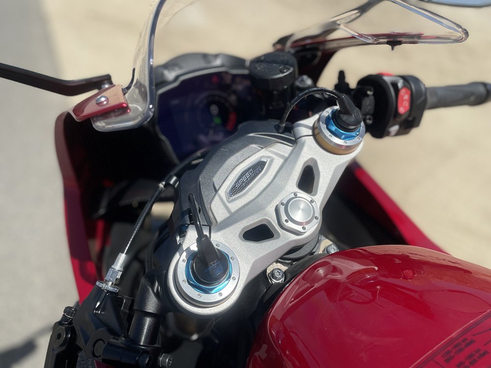 A close up view of the &Ouml;hlins EC 2.0 smart electronic suspension sensors on the front fork of the motorcycle