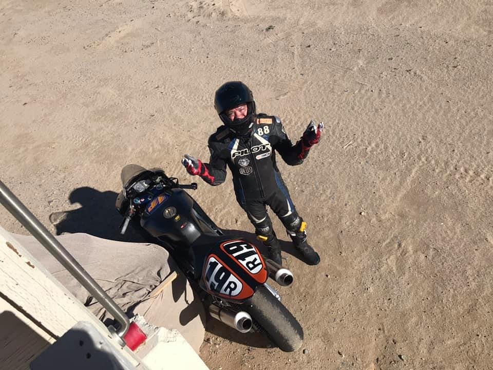 A motorcycle rider who has had a mechanical issue parks his bike under the corner tower