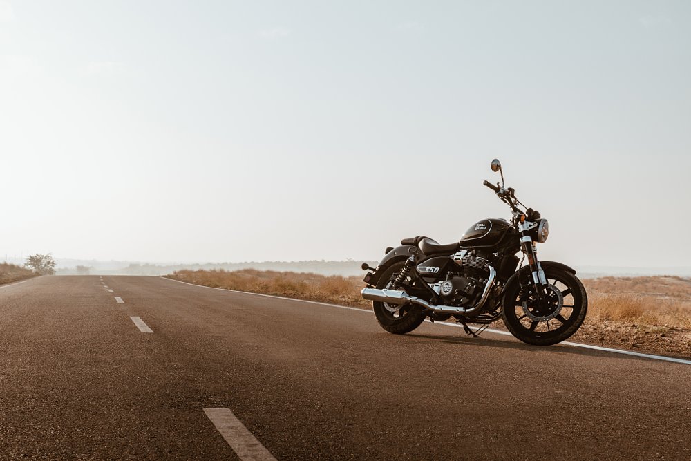 A super meteor in black sits on an empty desert road