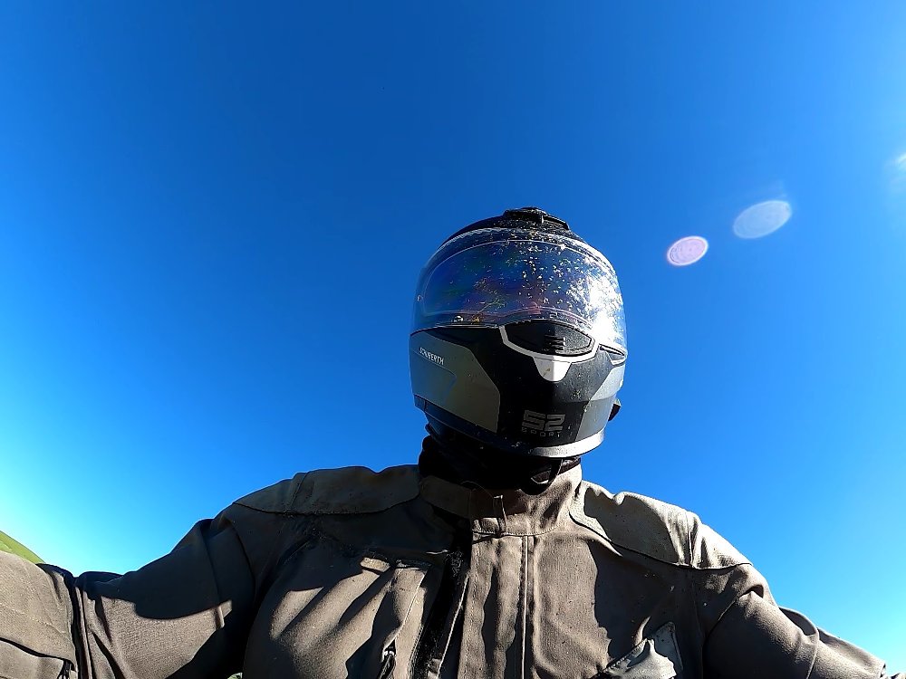 view of the rider with bug-splattered helmet