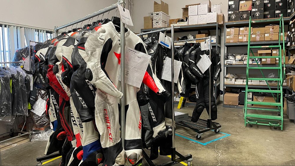 a photo of racks of leather suits waiting for repair