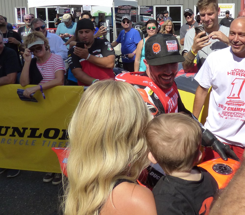 Herrin in victory lane greeted by his wife and baby boy