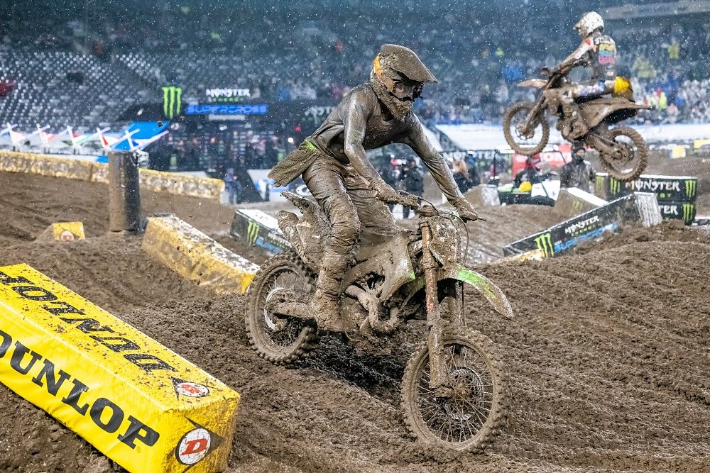 mud-covered motocross racer in the rain