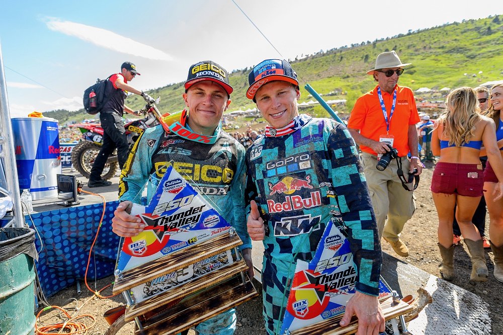 Alex Martin on the podium with a trophy at a motorcross race