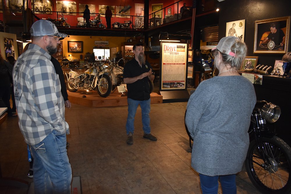 Matt Walksler explaining exhibits to visitors to the museum
