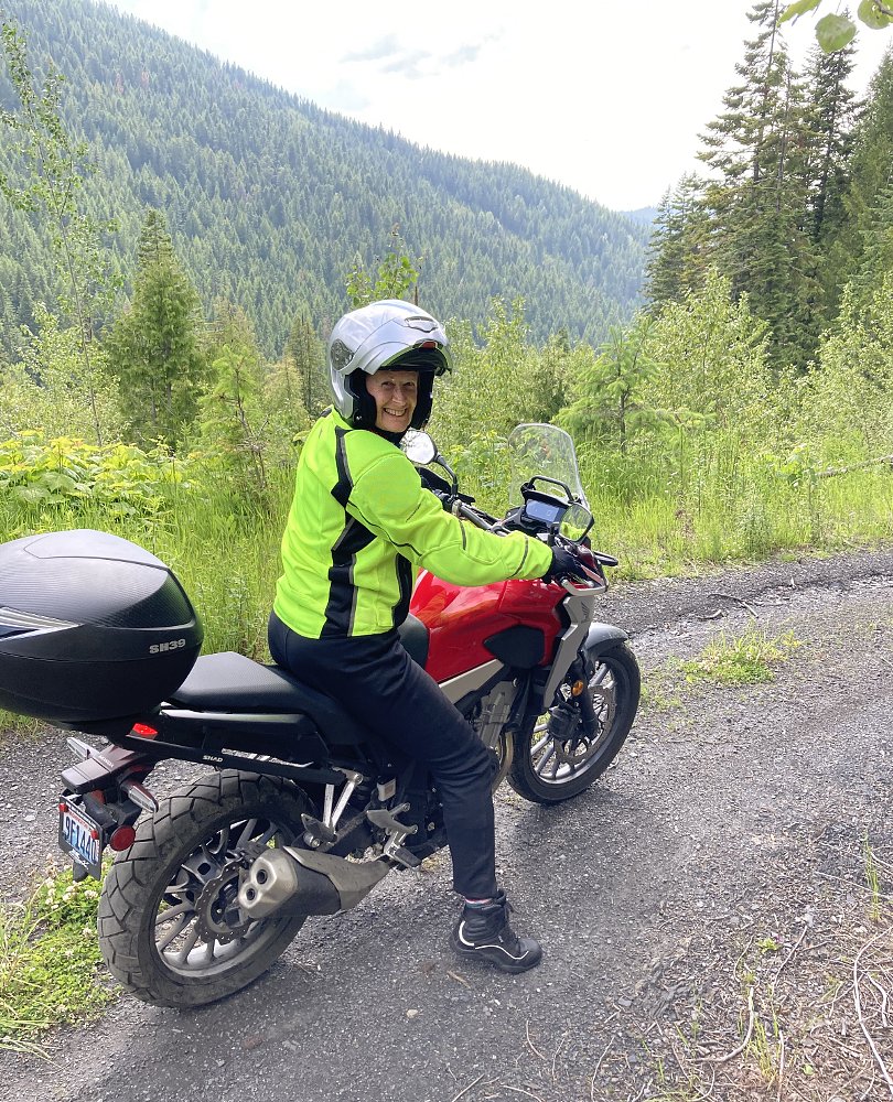 Diane on her motorcycle on a mountain road