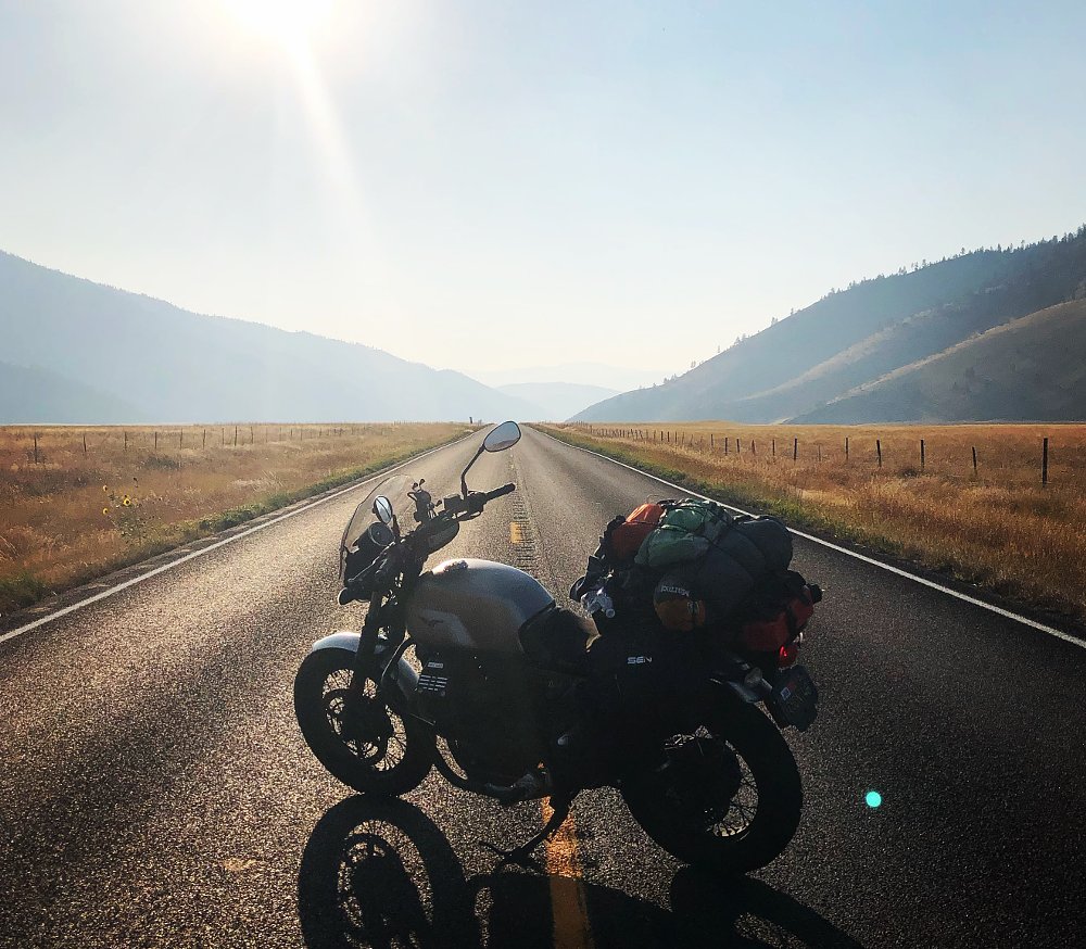motorcycle stopped on an empty road in Montana