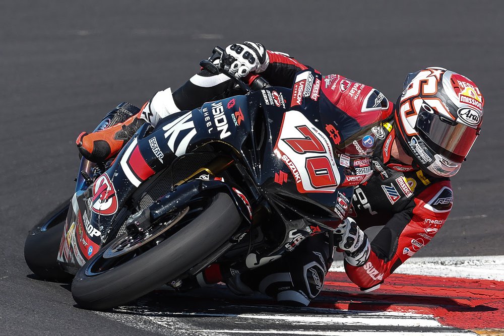 professional racer Tyler Scott leaned over at speed on a Suzuki on the track