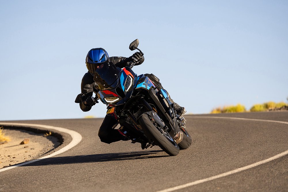 The BMW M 1000 XR on the road in a curve