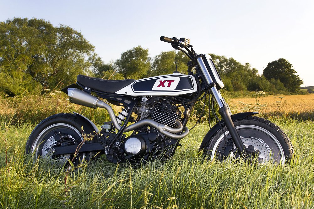 custom XT600 Yamaha parked in the tall grass