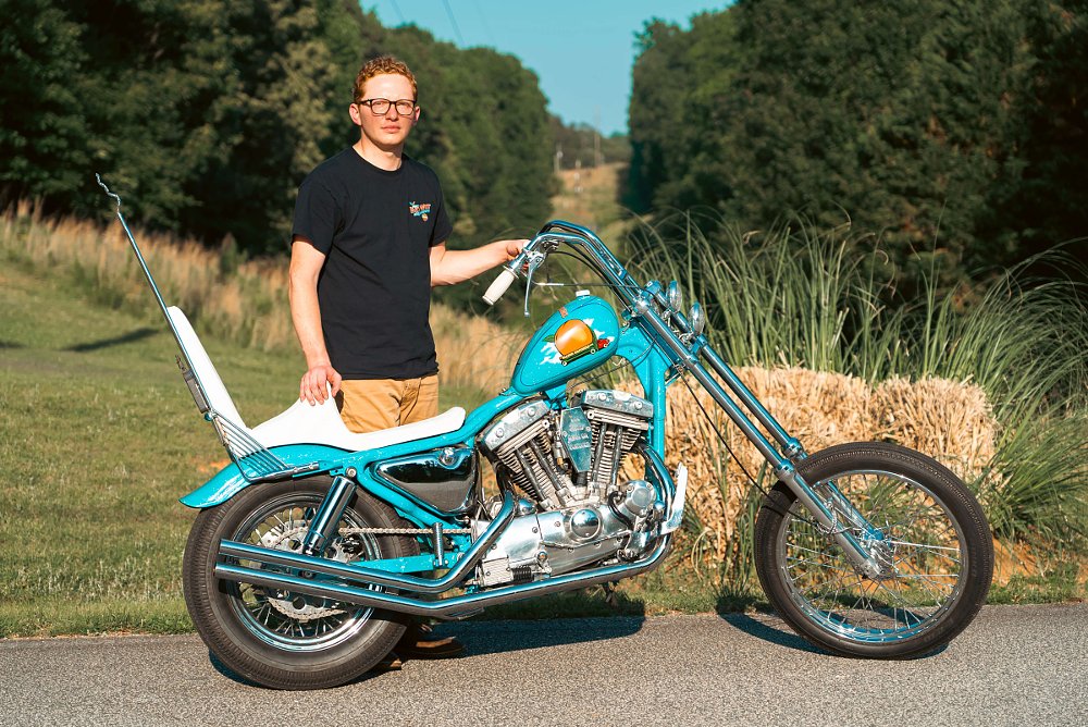 Caleb Swiney posing with his custom chopper