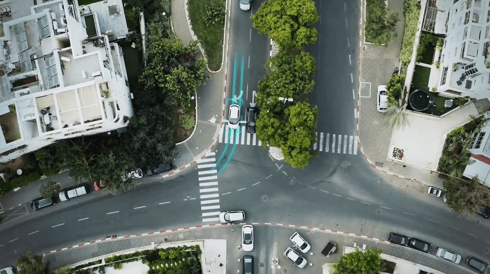 A top down view of a city street with teal lines showing where electric charging system is installed