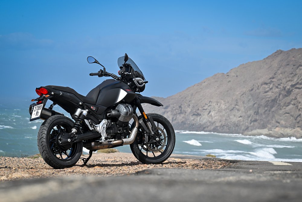V85 Strada parked along an oceanside road