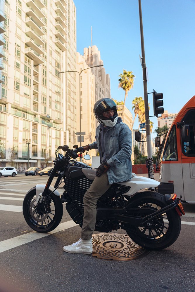 rider on a white Mulholland at a city stop light