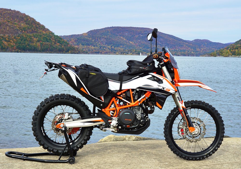 Tx3 in front of a country lake in autumn