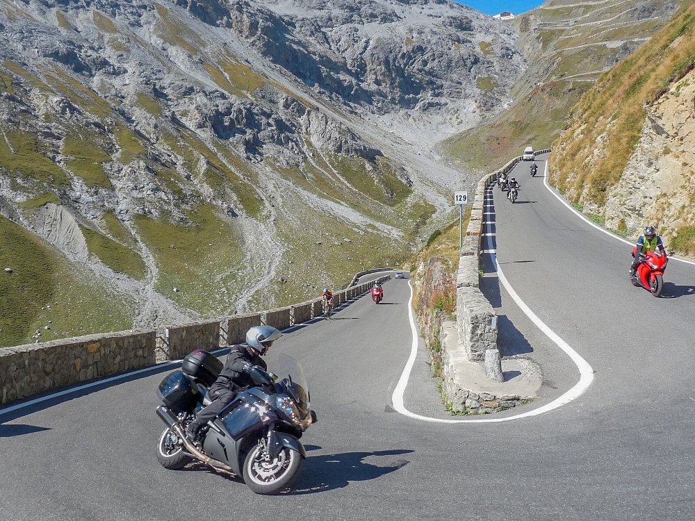 motorcycles on a hairpin road in the Alps
