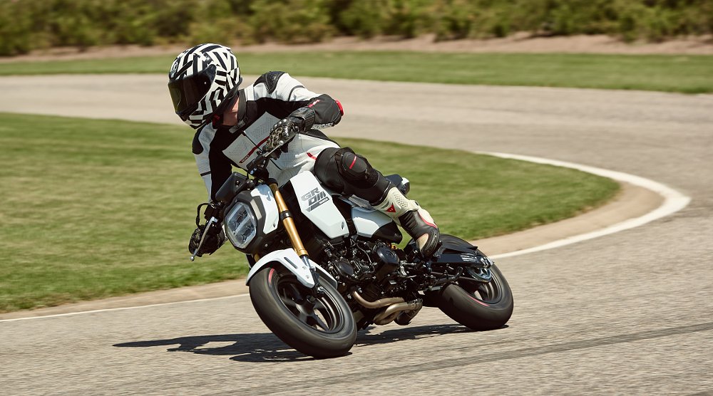 Andy racing the white Grom through a curve on the track