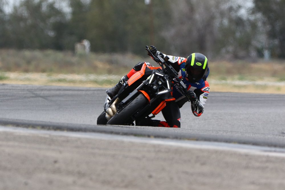 A KTM 1390 Super Duke R riding through Sunset corner at Buttonwillow Raceway Park.