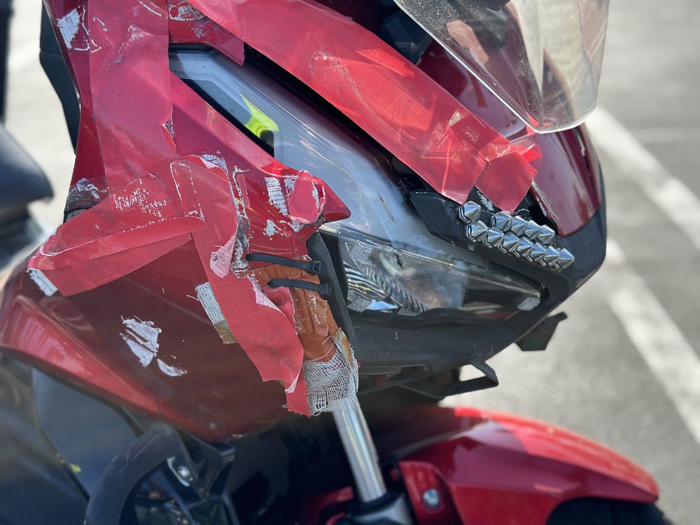 Detail image of damaged bodywork on a Honda ADV150 scooter.