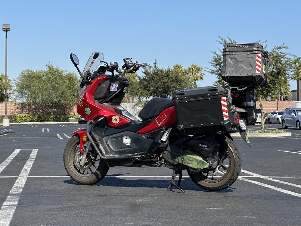 Rear three-quarter image of a Honda ADV150 scooter with saddlebags.